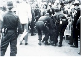 Police asrrest a demonstrator. 
      Select this for more 
      details on the picture.